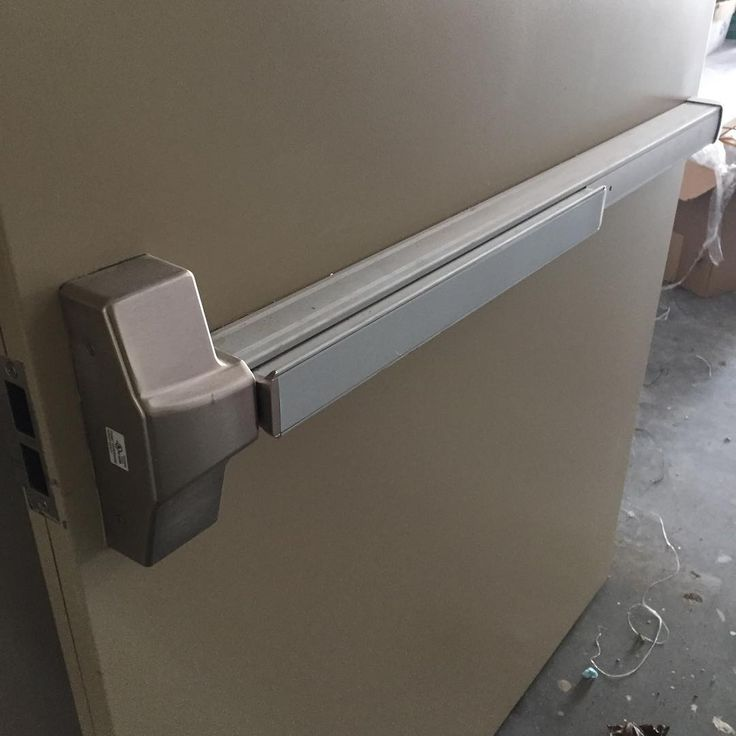 Door handle with a light, featuring a Panic Bar & Exit Devices, mounted on a wall for emergency access